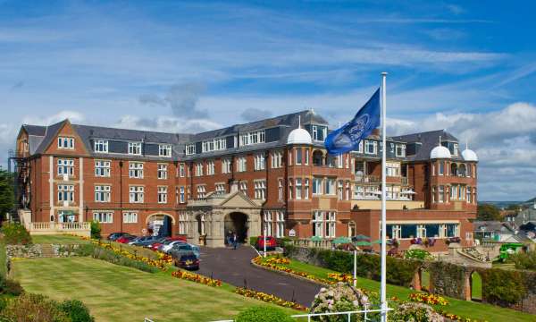 Victoria Hotel External View with Flag and Gardens