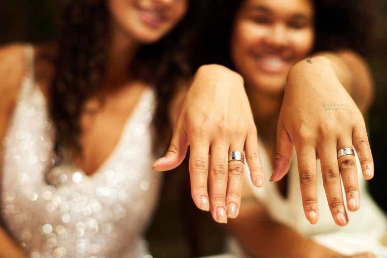 2 woman married hands with rings