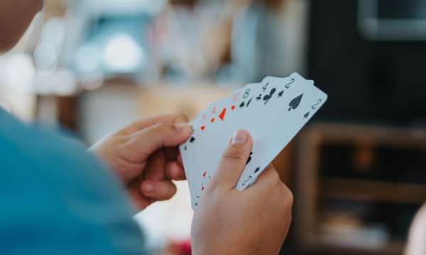 Person holding cards in hand