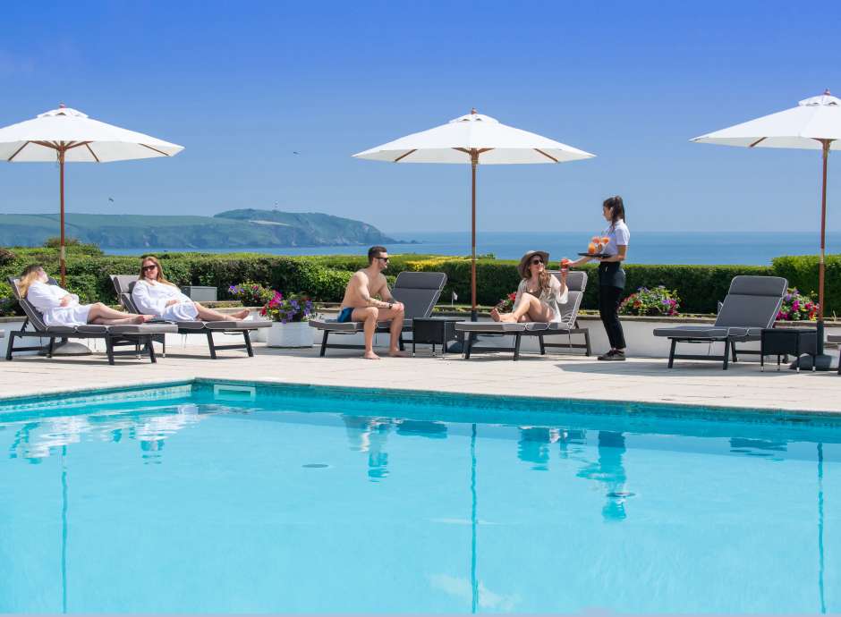carlyon bay outdoor pool with people being served drinks